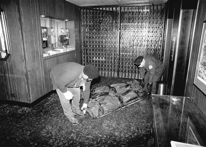 Torsos being carried through the lobby of the Travel Inn on the day of the murders, December 2, 1979.